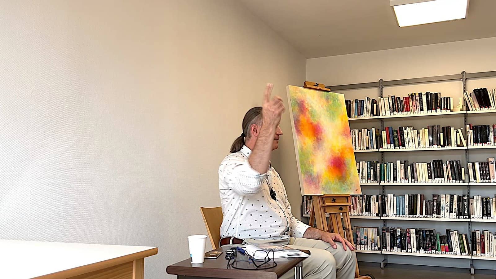 Pascal N. Paquette speaking at the Saint-Florentin library, one arm raised