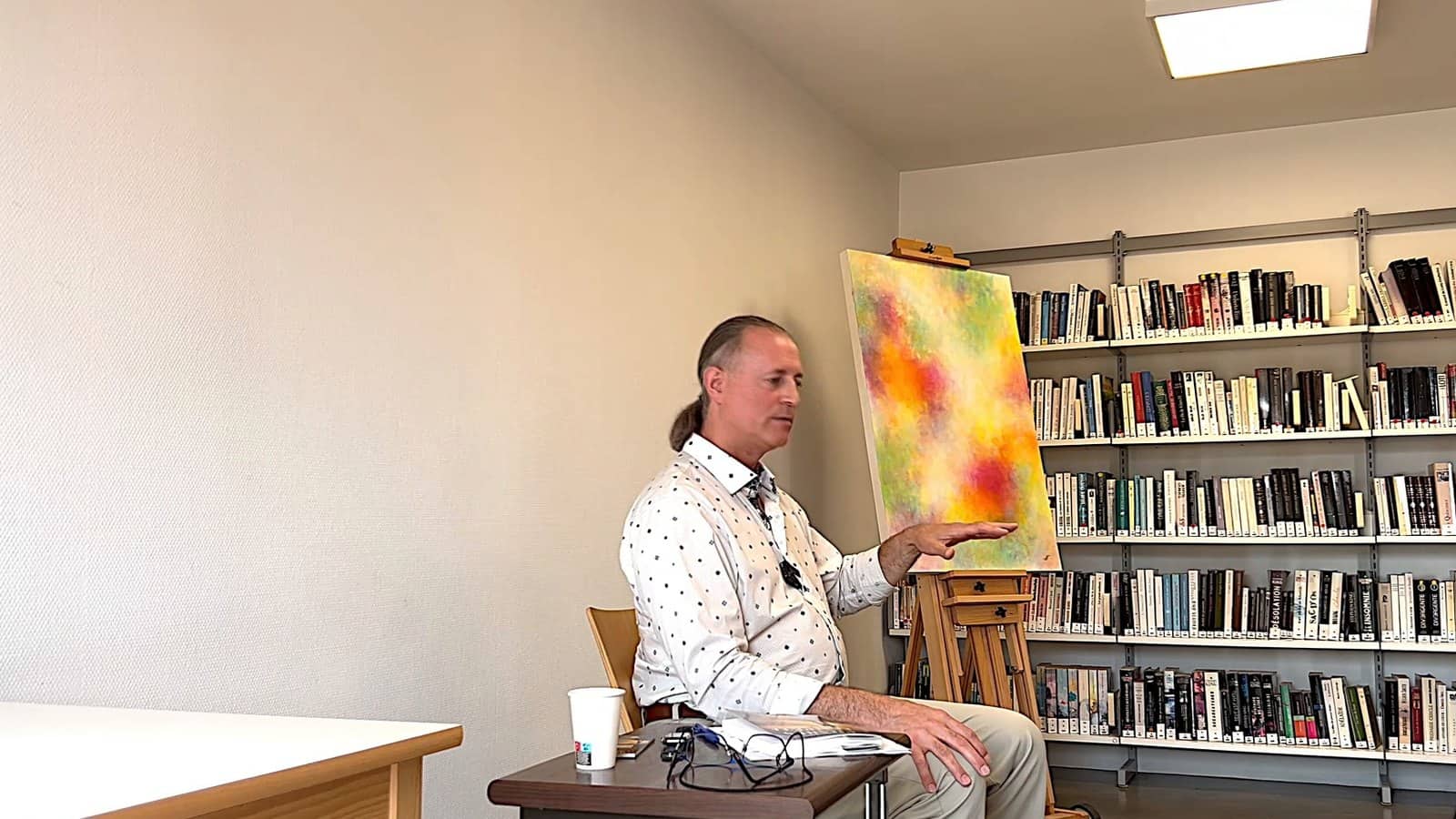 Pascal N. Paquette at the Saint-Florentin library, in front of a colourful canvas