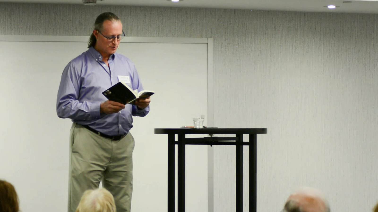Pascal N. Paquette at the Salon de l'Éveil, a book in hand