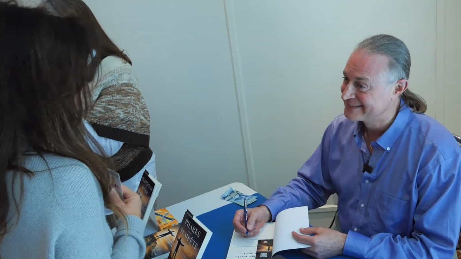 Pascal N. Paquette inscribing a book for a reader