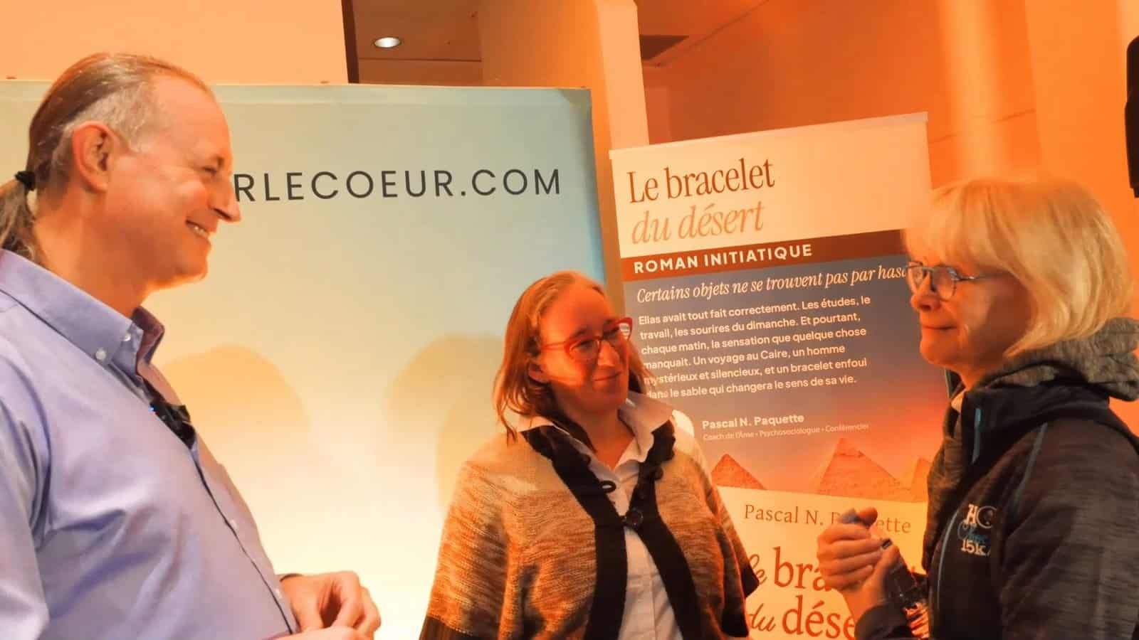 Pascal N. Paquette smiling, in conversation with two readers